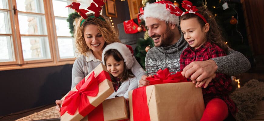 Family,Of,Four,Celebrating,Christmas,,Exchanging,Presents