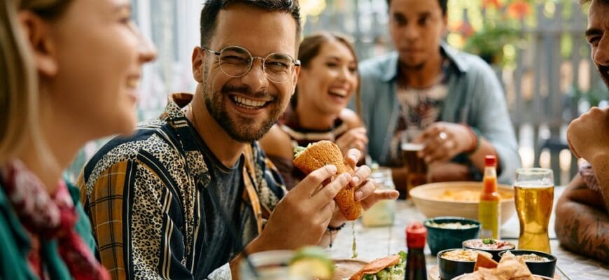 Happy,Man,Eating,Tacos,And,Talking,To,His,Friends,During